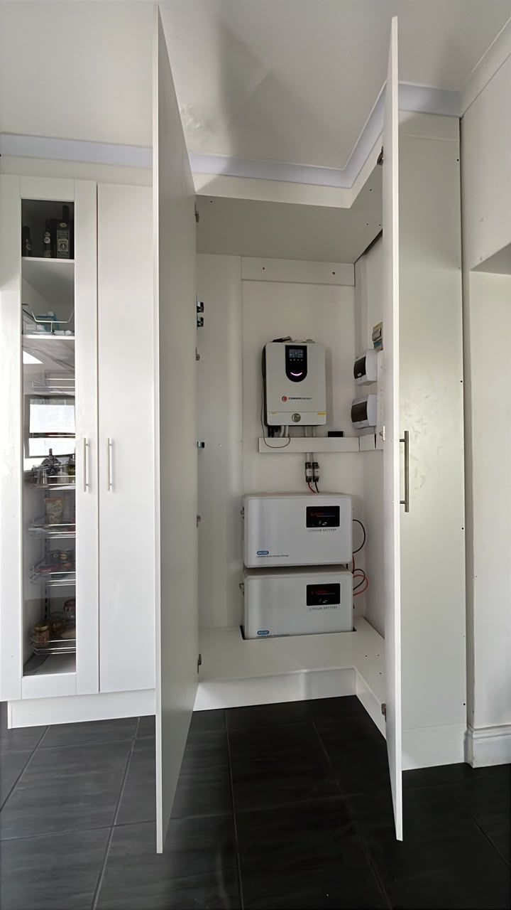 A pantry, an inverter bay and tall cupboards: The inverter bay open